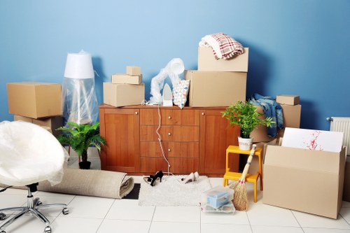 Local furniture collection team handling stair access in an Earls Court flat