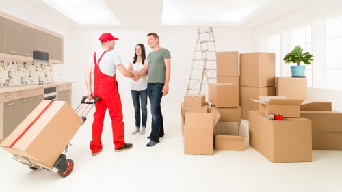 Specialist movers handling a piano through a narrow London property staircase